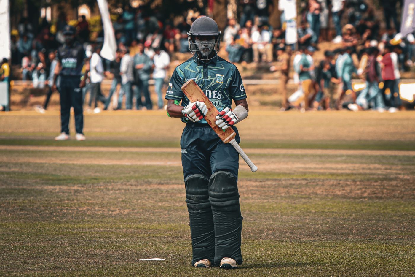Cricketer wearing batting gloves