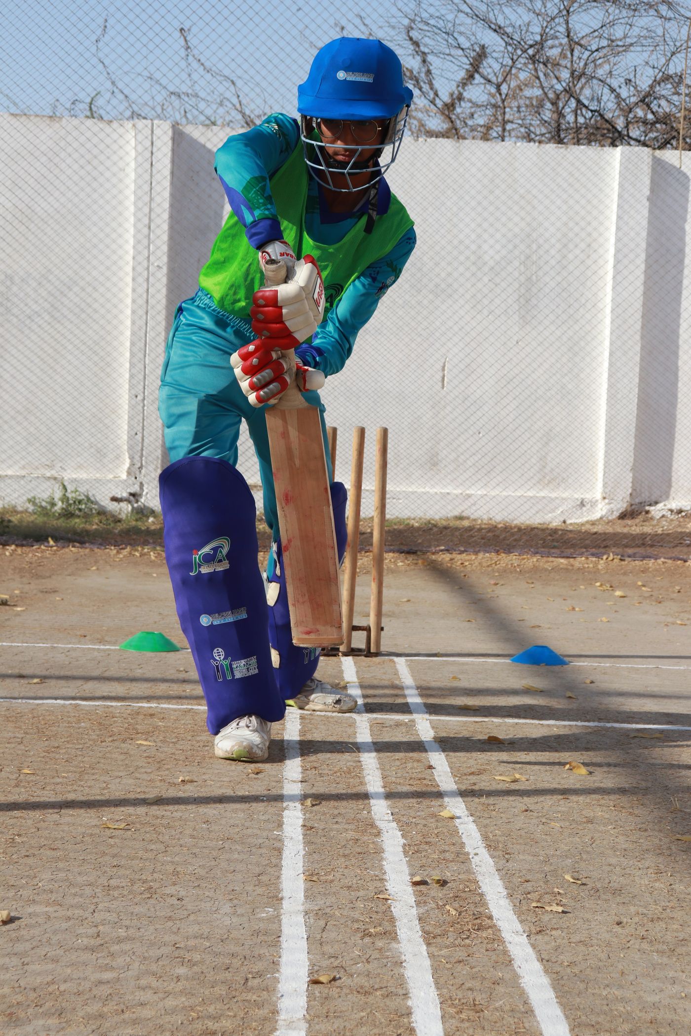 Cricketer practising in full gear